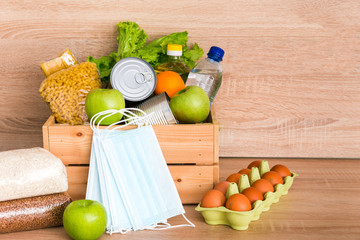 Charity donation wooden box with food, medical masks