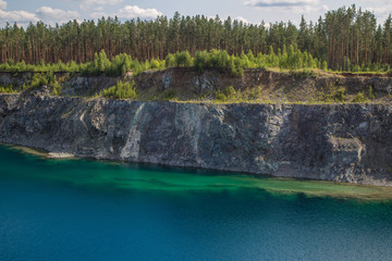 Flooded open pit chromium chrome ore quarry mine with blue water