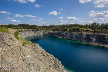 Flooded open pit chromium chrome ore quarry mine with blue water