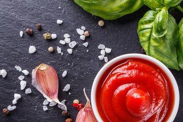 Fresh natural tomato ketchup on stone background