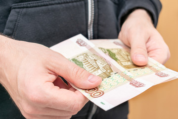 Person counts the money, Russian rubles, man's hands, close up