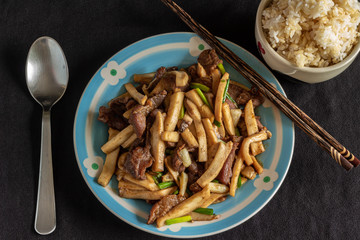 Dish of sun dried fried pork served with mushroom and spring onion, in Thai style.