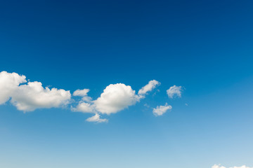 White cloud band against blue sky