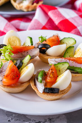 delicious snack tartlets on dark stone background