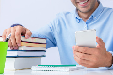 Guy with phone preparing for exams, men's hands, cropped image, close up