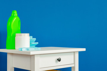 Blue clothes pins on white wooden table