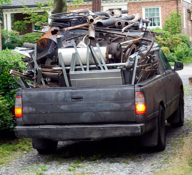 Rear view of junkman's truck filled with recyclable scrap metal.