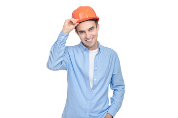 Constructor takes off his helmet and looks at the camera, isolated background, copy space