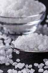 coarse sea salt on a dark stone background