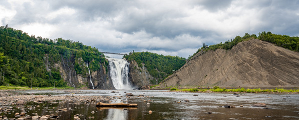 Cloudy summer day with insane view of beautiful and powerful Montmorency waterfall 