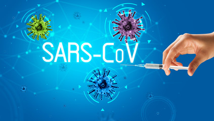 Syringe, medical injection in hand with SARS-CoV inscription, coronavirus vaccine concept