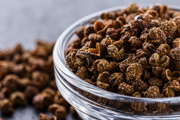 Sichuan pepper on a dark stone background