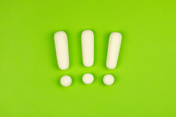 Three exclamation marks on a green background. Important information concept, warning. Keep attention sign.