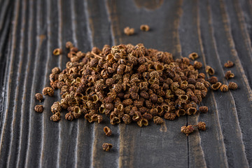 Sichuan pepper on a dark wooden rustic background