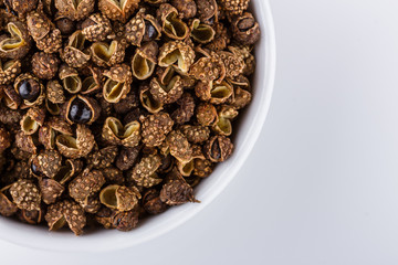 fragrant Sichuan pepper on white acrylic background