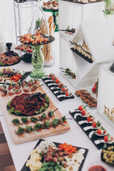 Christmas table feast. Delicious Italian delicatessen, prosciutto snacks, cheese and olives, appetizers on table at wedding reception in restaurant. Luxury catering service