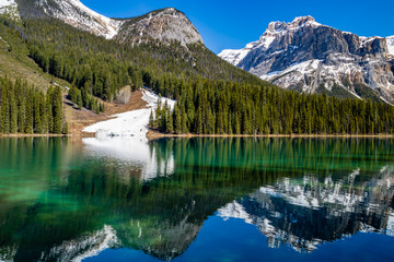 Last vestages of winter hang onto Emerald Lake. Yoho National Park. British Columbia, Canada.