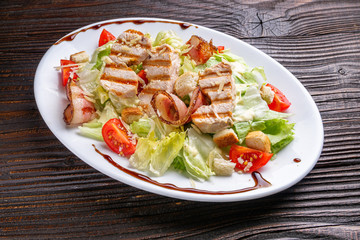 Caesar salad on dark wooden rustic background