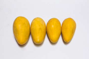 Bunch of yellow sweet mangoes on white background