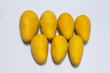 Bunch of yellow sweet mangoes on white background