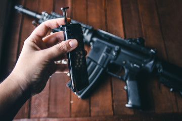 against the background of a person hand holding a rifle loader for filling balloons airsoft