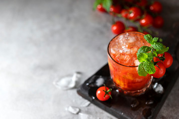 Ice tomato juice in a glass goblet.