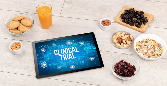 CLINICAL TRIAL Concept In Tablet Pc With Healthy Food Around, Top View