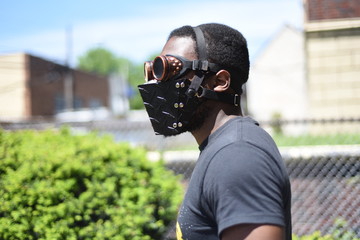 Stylish and fashion american man wearing a mask during coronavirus time. Face ultra fashion mask for protection face in pandemic isolation time. 