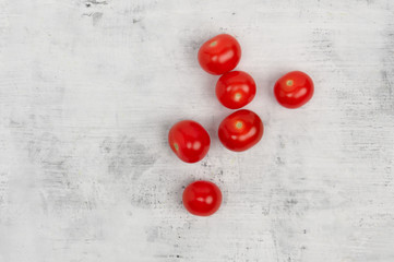 Cherry tomatoes lie on a white-black background