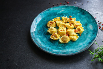 tortellini, pasta with filling (ravioli or dumplings) Menu concept. food background. top view copy space