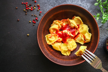 tortellini, pasta with filling (ravioli or dumplings) Menu concept. food background. top view copy space