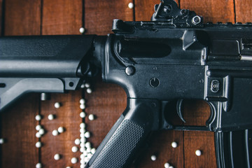 on a wooden table closeup details are visible airsoft rifles
