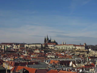 Naklejka na ściany i meble Panoramic view on Prague buildings surrounding Old Town Square and on St Vitus Cathedral from Old City Hall tower. These are ones of most popular tourist routes in capital of Czech Republic