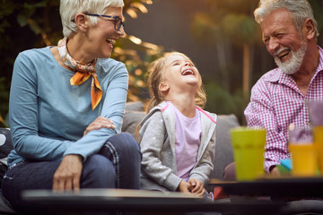 Happy  granddaughter laughing  with her  grandparents.Happy childhood,family and relationships.