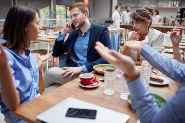 group of young people talking  at lunch. friends, colleagues, business partners concept