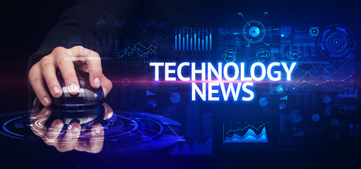 hand holding wireless peripheral with TECHNOLOGY NEWS inscription, modern technology concept