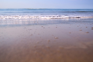 blurred background of a sandy beach with waves