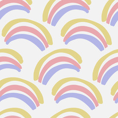Vector seamless colorful pattern with cute little hand-drawn rainbows in pastel colors. The design is perfect for wallpapers, backgrounds, fashion design, clothes, advertisement, decorations, stickers