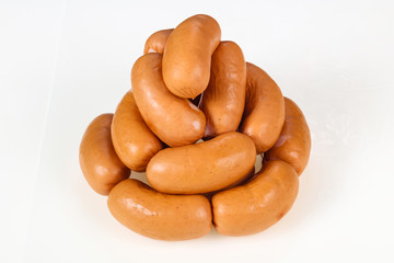 Tasty meat sausages over white background