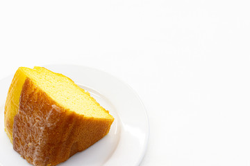 Closeup piece of sweet lemon cake served on white plate,Copy space.