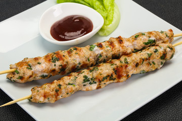 Minced pork skewer kebab with sauce