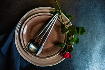 Table setting with red rose