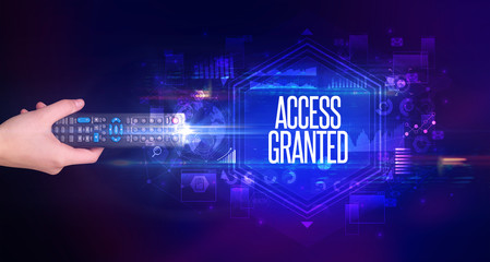 hand holding wireless peripheral with ACCESS GRANTED inscription, cyber security concept