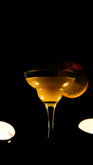 orange cocktail glass close up on a black background