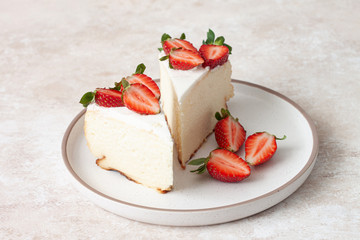 Homemade cheesecake with fresh strawberries and mint leaves