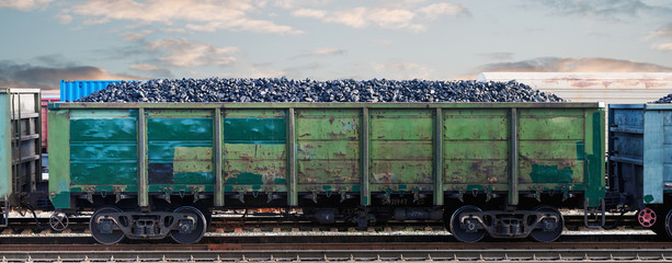Railway wagon loaded with coal. Coal freight train at the railway station. Coal wagon, mining and...
