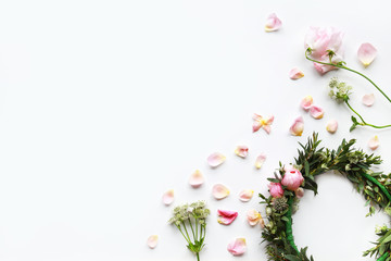 Tender floral frame made of sweet pea flowers, pink roses and grean leaves. Floral crown. Pastel background for wedding invitation.