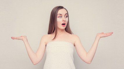 Amazed girl shows palms free space for advertising, empty space, portrait, white background, 16:9