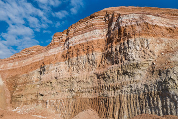 Vertical geological cut of working ground wall or board in industrial quarry, containing  layers of...