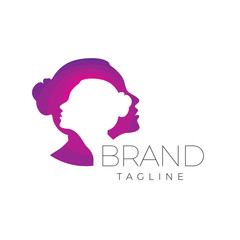 The concept of an abstract logo of two women with negative space and color gradations. Unique, minimalist suitable for salons and beauty products.